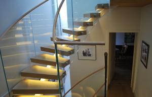 Cheap Stainless Steel Curved Glass Staircase Modern House Decoration With Wall Mounted Handrails wholesale