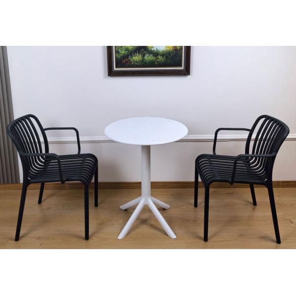 Stacked plastic dining chairs demonstrating space-saving feature